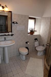 a bathroom with a sink and a toilet and a mirror at Apartment Piazza Matteotti in Greve in Chianti