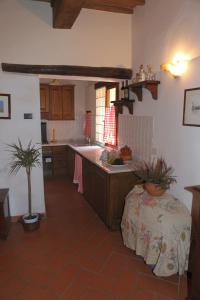 a kitchen with a sink and a table in it at Apartment Piazza Matteotti in Greve in Chianti