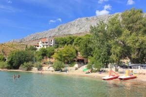 a group of people in the water at a beach at Apartments with a parking space Duce, Omis - 2778 in Duće