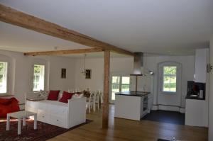 a living room with a white couch and a kitchen at Goldschmiedsmühle in Lindau