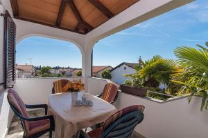 a table and chairs on a balcony with a view at Apartments with parking space Novigrad - 2536 in Novigrad Istria