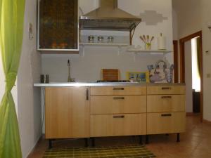 a kitchen with wooden cabinets and a stove at Holiday Home Il Sogno A San Pietro in Rome +35 photos