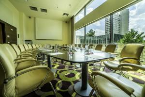 a conference room with tables and chairs and a screen at Flamingo Grand Hotel & Spa in Albena +37 photos