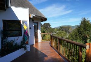 a deck with a view of the mountains at Badger's Lodge in Knysna