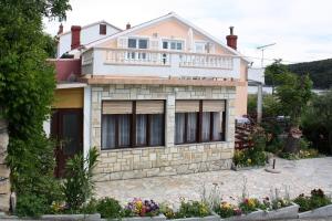 a house with a balcony on top of it at Apartments with a parking space Kampor, Rab - 4985 in Kampor