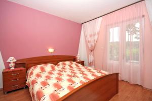 a bedroom with a bed and a large window at Apartments with a parking space Kampor, Rab - 4985 in Kampor