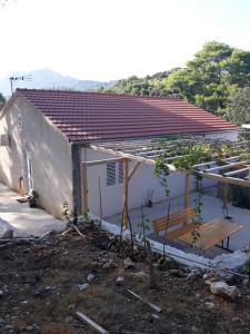 a house with a roof that is under construction at Apartments by the sea Cove Blaca, Mljet - 4899 in Saplunara