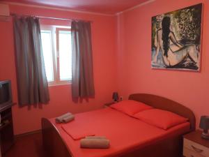 a red bedroom with a bed with red sheets and a window at Apartments by the sea Cove Blaca, Mljet - 4899 in Saplunara