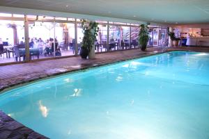 a large blue swimming pool in a hotel at Hôtel in Le Lavandou