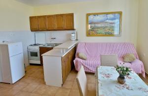 a kitchen with a couch and a table in a kitchen at Apartments with a parking space Kampor, Rab - 5000 in Rab