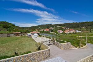a view of a yard with a stone wall at Apartments with a parking space Palit, Rab - 4971 in Rab