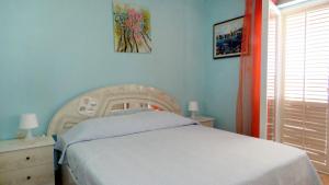 una camera da letto con un letto e un quadro sul muro di Family-friendly apartments with swimming pool Barbat, Rab - 4988 a Rab Altre 32 foto