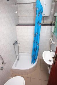 a bathroom with a tub and a toilet and a sink at Apartments by the sea Supetarska Draga - Gonar, Rab - 4989 in Supetarska Draga
