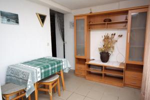 a small room with a table and a cabinet at Apartments by the sea Supetarska Draga - Gonar, Rab - 4989 in Supetarska Draga