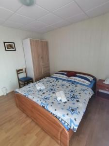 a bedroom with a bed with a blue comforter at Apartments with parking space Lopar, Rab - 5019 in Lopar