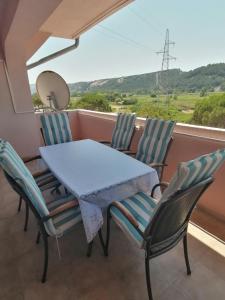 a table and chairs on a balcony with a view at Apartments with a parking space Lopar, Rab - 5019 in Lopar