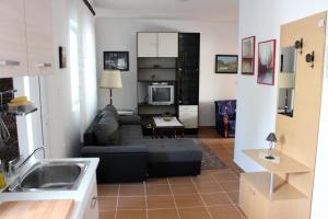 a kitchen and a living room with a couch at Apartments by the sea Selce, Crikvenica - 4801 in Selce