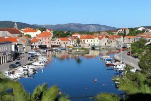 a view of a town with boats in a river at Apartments by the sea Vrboska (Hvar) - 4601 in Vrboska