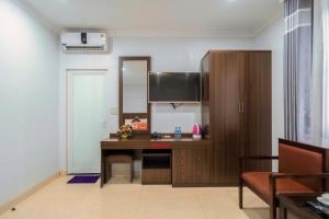a room with a desk and a large mirror at De Charm Hạ Long Hotel in Ha Long