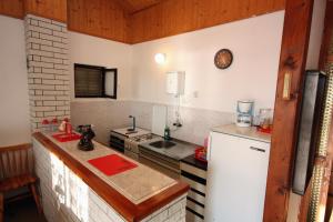 a small kitchen with a sink and a refrigerator at Apartments by the sea Sevid, Trogir - 5221 in Sevid
