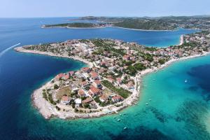 an island in the middle of the water at Apartments by the sea Sevid, Trogir - 5221 in Sevid