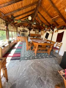 a living room with a table and chairs and a kitchen at Sun House in Tryavna