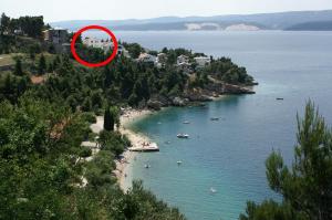 a view of a beach with boats in the water at Apartments by the sea Balica Rat, Omis - 4868 in Čelina