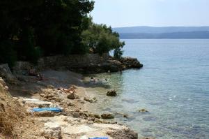 a group of people in the water at a beach at Apartments by the sea Balica Rat, Omis - 4868 in Čelina