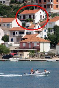 a group of people in a boat in the water at Apartments by the sea Tisno, Murter - 5136 in Tisno