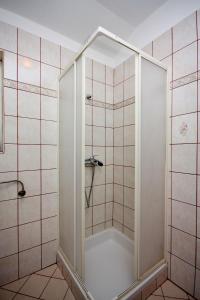 a shower with a glass door in a bathroom at Apartments with a parking space Kampor, Rab - 5018 in Rab