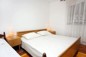 Okuklje的住宿－Apartments by the sea Okuklje, Mljet - 4933，一间卧室设有两张床和窗户。