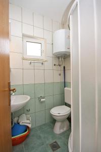 a small bathroom with a toilet and a sink at Apartments by the sea Cove Saplunara, Mljet - 4896 in Maranovići