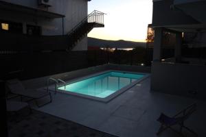 a swimming pool on the side of a building at Family friendly apartments with a swimming pool Tisno, Murter - 5073 in Tisno