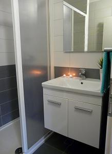 a bathroom with a white sink and a shower at Apartments by the sea Drvenik Donja vala, Makarska - 6756 in Drvenik