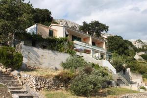 a house on the side of a hill at Apartments with a parking space Brela, Makarska - 6884 in Brela