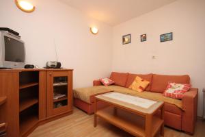 a living room with a couch and a tv at Apartments with a parking space Brela, Makarska - 6884 in Brela