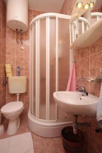 a bathroom with a shower and a toilet and a sink at Apartments with a parking space Brela, Makarska - 6884 in Brela