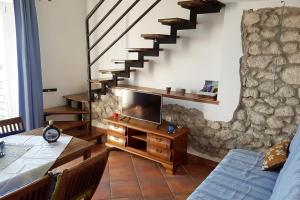 a living room with a tv and a staircase at Apartments by the sea Gradac, Makarska - 6661 in Gradac