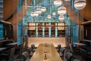 a dining room with a long table and chairs at Le Meridien Bangkok in Bangkok +159 photos