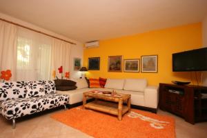 a living room with a couch and a tv at Apartments with a parking space Makarska - 6636 in Makarska