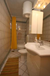 a bathroom with a sink and a toilet at Apartments with a parking space Makarska - 6636 in Makarska