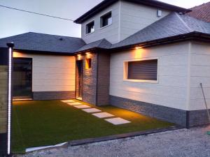 a house with a green lawn in front of it at Le gîte suspendu et sa chambre cachée in Saint-Blimont +16 photos