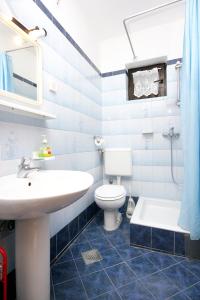 a bathroom with a sink and a toilet and a tub at Apartments with parking space Pag - 6535 in Pag
