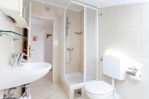 a bathroom with a toilet and a sink and a shower at Apartments by the sea Podgora, Makarska - 6671 in Podgora