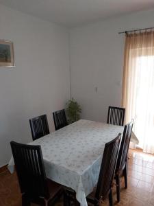 a dining room table and chairs with a white table and a table and chairsktop at Apartments with a parking space Tar, Porec - 6943 in Tar