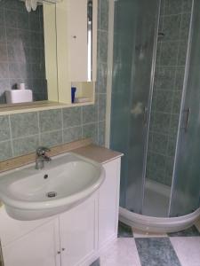 a bathroom with a sink and a shower at Apartments with a parking space Tar, Porec - 6943 in Tar