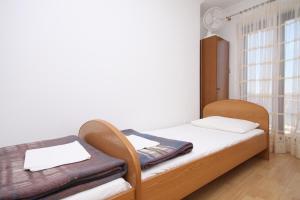 a small bedroom with a bed and a window at Apartments by the sea Metajna, Pag - 6497 in Zubovići +84 photos