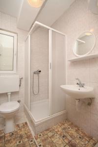 a bathroom with a shower and a toilet and a sink at Apartments with a parking space Zubovici, Pag - 6520 in Zubovići