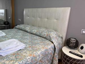 a bedroom with a bed with a quilt on it at Gijón Playa by FlowHome in Gijón