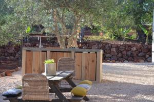 a picnic table with two chairs and a table with at Algarve Olive Tree Lodge in Nora